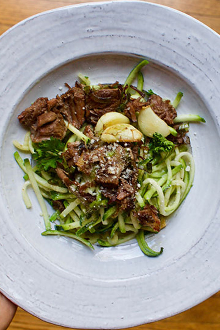braised beef and garlic over zucchini noodles
