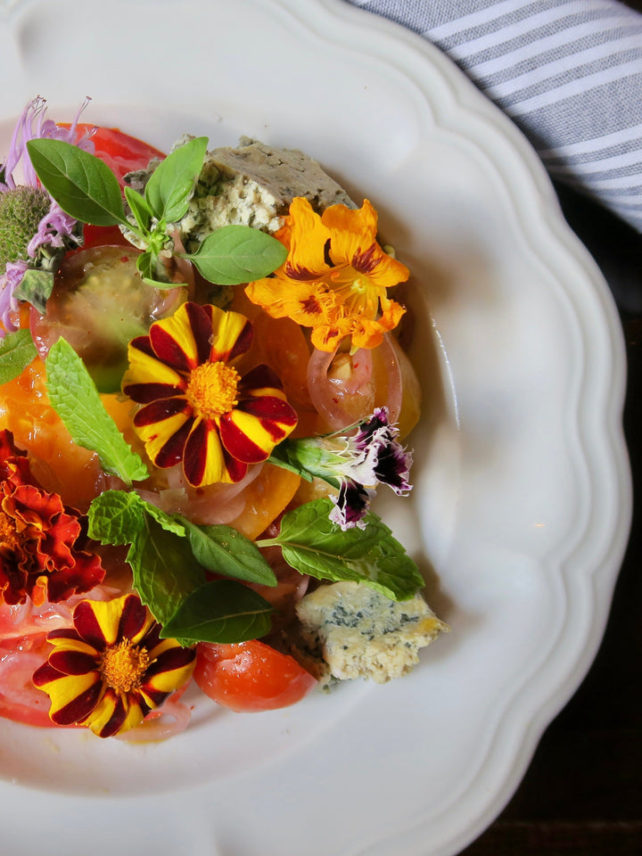 heirloom tomato salad with edible flowers, blue cheese & herbs