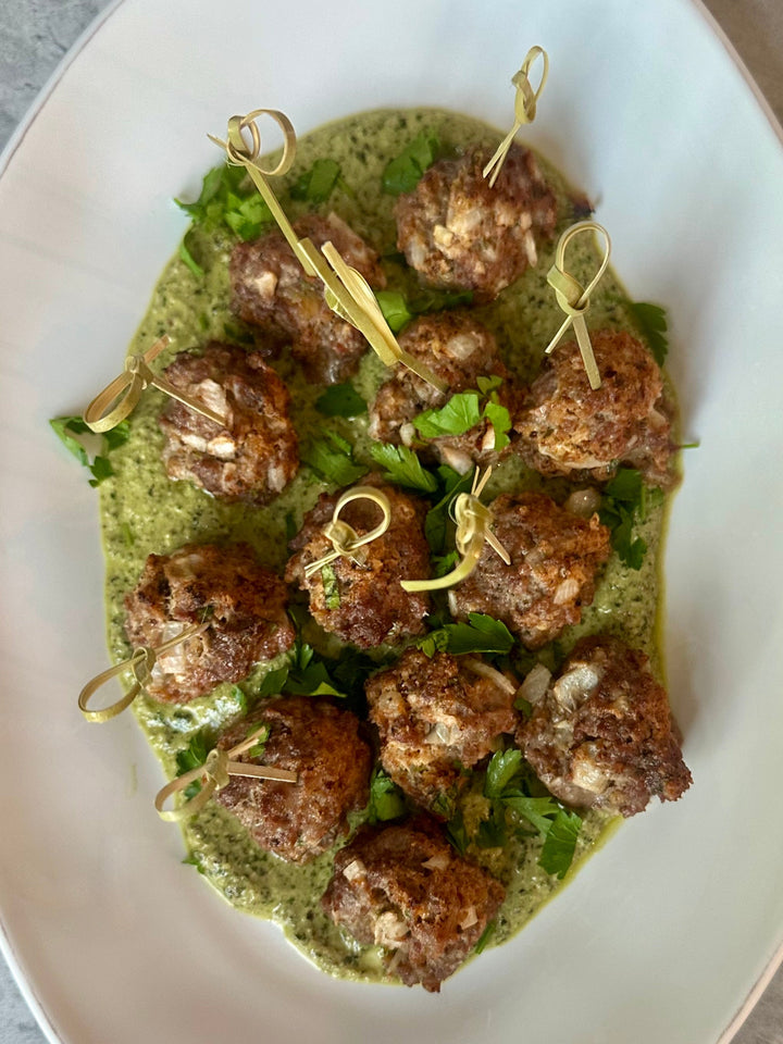 ultimate pork + beef meatballs with tangy yogurt over pesto